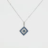 A delicate 14K white gold chain necklace featuring a geometric diamond-shaped pendant adorned with natural blue sapphires and sparkling white diamonds, displayed on a clean white studio background.