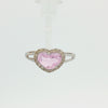 Heart-shaped pink topaz ring with a sparkling diamond halo and polished white gold split-shank band.