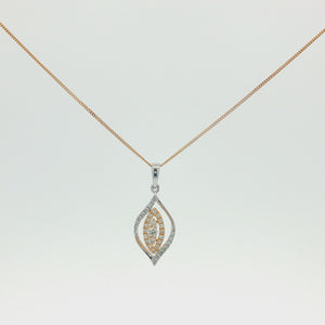 A two-tone leaf-shaped pendant necklace on a delicate gold chain, featuring a silver-toned outer border with pavé-set clear stones and a gold-toned center with yellow-stone accents, shown against a plain white background.
