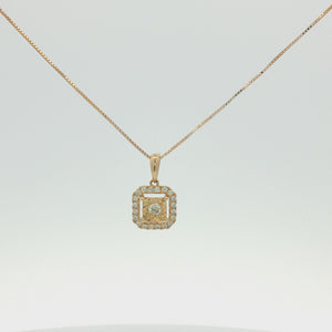 A gold square pendant necklace featuring a halo of small clear stones around a central round clear stone, suspended from a delicate gold chain on a white background.