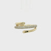 A gold wrap ring featuring a central row of pavé-set round diamonds on one band, with polished gold prongs and open wrap-around ends, shown on a plain white background.