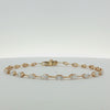 A yellow gold tennis bracelet featuring a series of marquise-cut and round diamonds set along the chain, displayed on a clean white background.