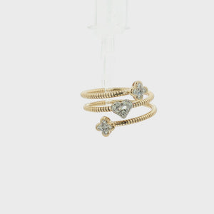 A gold snake-style wrap bracelet featuring a central pavé heart and two flower motifs, each set with clear stones, shown on a plain white background.