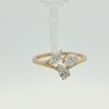 A yellow gold ring featuring three marquise-cut diamonds on a split shank, photographed on a clean white background.