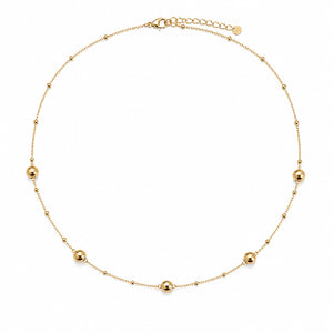 A delicate gold chain necklace featuring five evenly spaced, polished round bead accents, displayed on a clean white background.