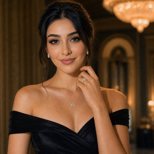 Woman in a black off-shoulder dress with jewelry in an elegant indoor setting