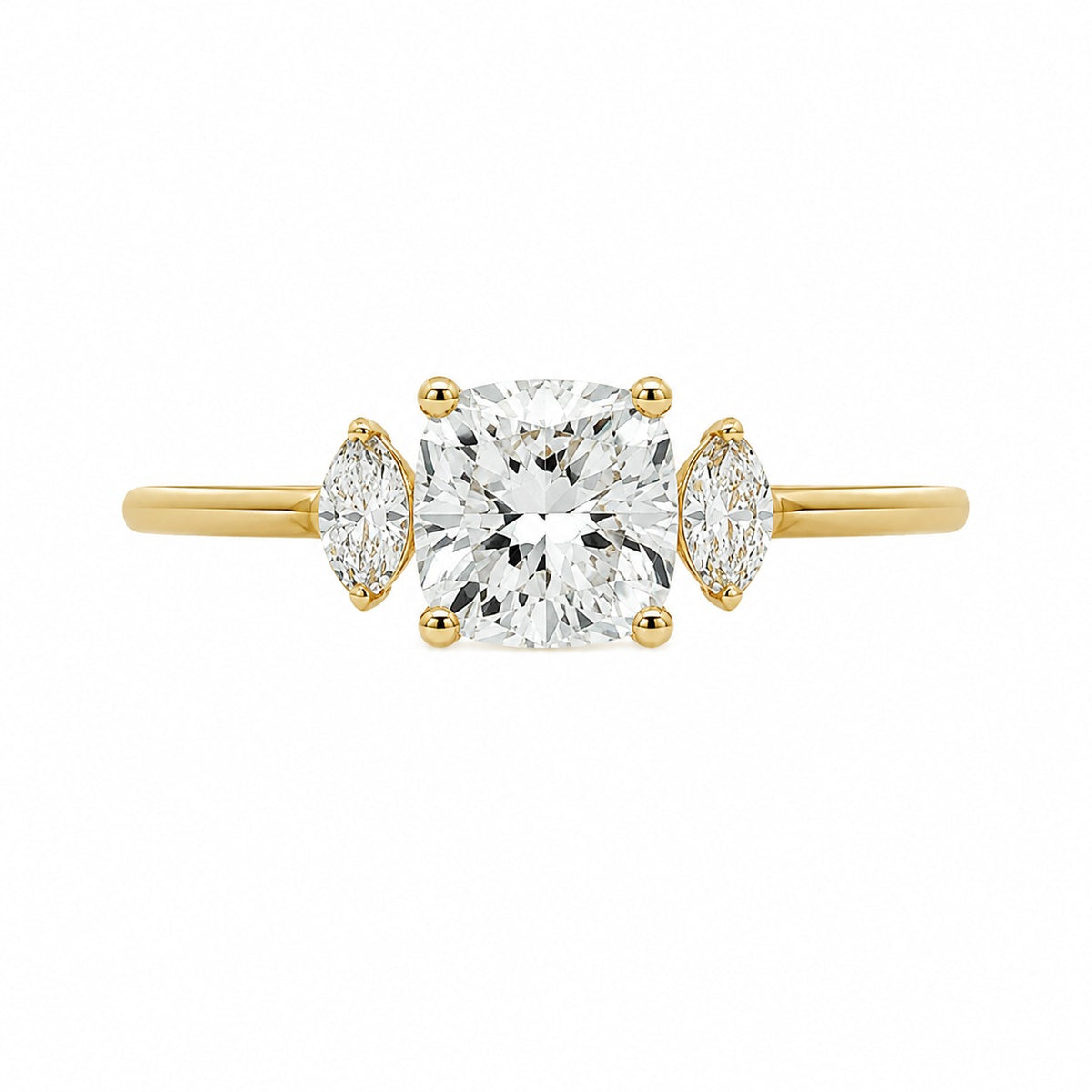 A yellow gold three-stone engagement ring featuring a large cushion-cut center diamond flanked by two marquise-cut side diamonds, set against a plain white background.